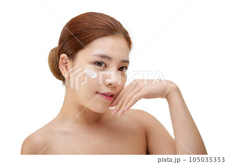 beautiful young woman with clean skin and moisturizing cream beautiful young woman with clean skin and moisturizing cream 105035353