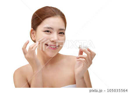 beautiful young woman with clean skin and moisturizing cream 105035564