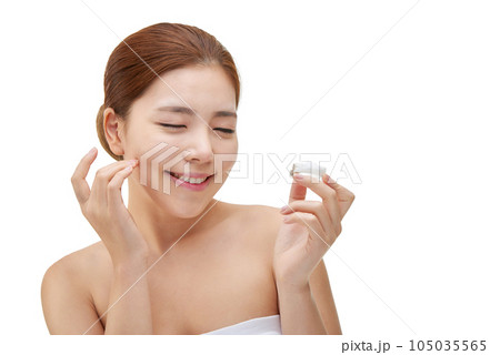 beautiful young woman with clean skin and moisturizing cream beautiful young woman with clean skin and moisturizing cream 105035565
