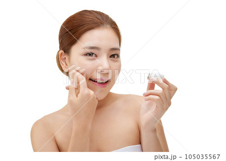 beautiful young woman with clean skin and moisturizing cream beautiful young woman with clean skin and moisturizing cream 105035567