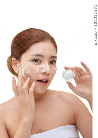 beautiful young woman with clean skin and moisturizing cream beautiful young woman with clean skin and moisturizing cream 105035571
