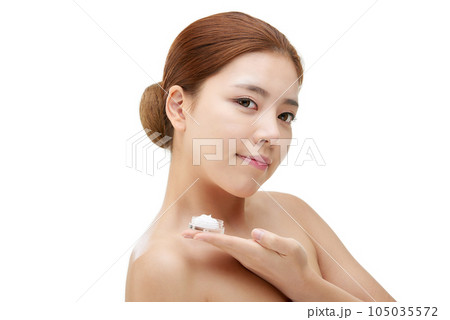 beautiful young woman with clean skin and moisturizing cream beautiful young woman with clean skin and moisturizing cream 105035572