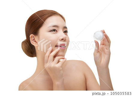 beautiful young woman with clean skin and moisturizing cream beautiful young woman with clean skin and moisturizing cream 105035583