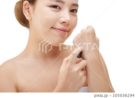 portrait of a young woman taking care of her skin 105036294