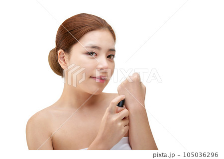portrait of a young woman taking care of her skin 105036296