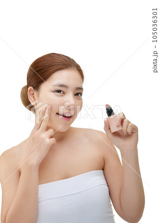 portrait of a young woman taking care of her skin 105036301