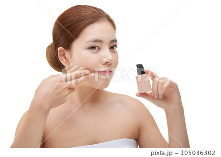portrait of a young woman taking care of her skin 105036302