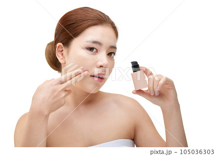 portrait of a young woman taking care of her skin 105036303