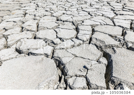 Dry, cracked soil Dry, cracked soil 105036384