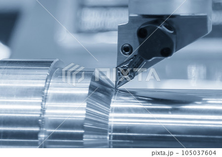 Close up  the metal shaft part and the lathe tool in the light blue scene. 105037604