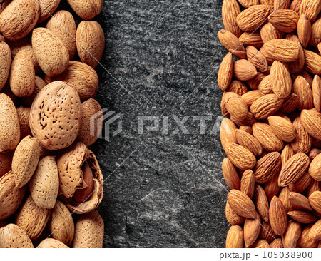 Almonds on a stone background. Almonds on a stone background. 105038900