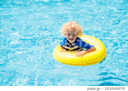 Child in swimming pool. Kids swim. Water play. Child in swimming pool. Kids swim. Water play. 105040074