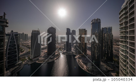 Sunrise over tall residential buildings at JLT aerial all day timelapse 105040334