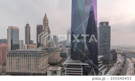 Dubai International Financial district aerial night to day timelapse. View of business office towers. Dubai International Financial district aerial night to day timelapse. View of business office towers. 105040455