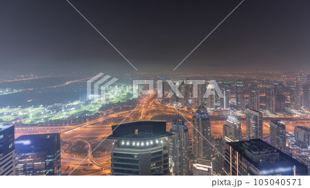 Panorama of Dubai Marina with JLT skyscrapers and golf course night timelapse, Dubai, United Arab Emirates. Panorama of Dubai Marina with JLT skyscrapers and golf course night timelapse, Dubai, United Arab Emirates. 105040571