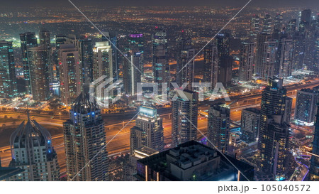 JLT and Dubai marina skyscrapers near Sheikh Zayed Road aerial day to night timelapse. Residential buildings 105040572