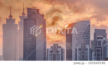 Dubai skyscrapers with golden sunset over business bay district timelapse. 105040596