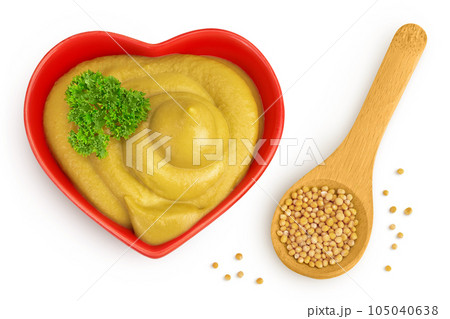 Mustard sauce in ceramic bowl with seed isolated on white background. Top view. Flat lay 105040638