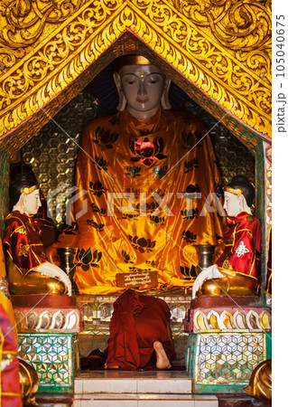 Buddhist monk praying in Shwedagon Paya pagoda. Yangon, Myanmar Buddhist monk praying in Shwedagon Paya pagoda. Yangon, Myanmar 105040675