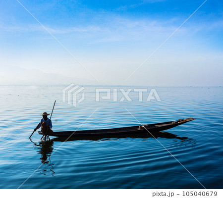 Myanmar travel attraction landmark - Traditional Burmese fisherman at Inle lake, Myanmar famous for their distinctive one legged rowing style 105040679
