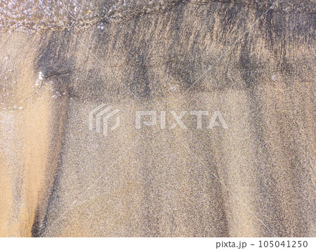 Beach wet sand texture. Sandy shore beige background. Beach wet sand texture. Sandy shore beige background. 105041250