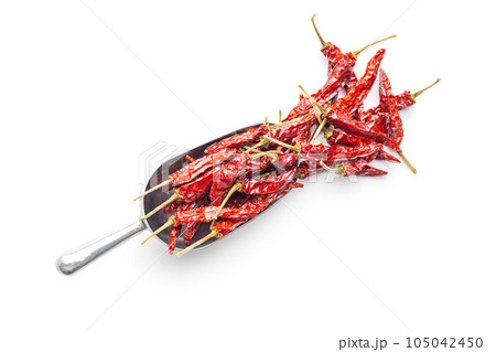 Red chili peppers in scoop isolated on white background. 105042450