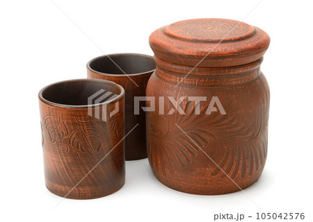 Large clay pot and cups isolated on white Large clay pot and cups isolated on white 105042576