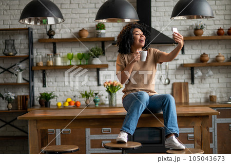 Cute woman with a phone in hands looking excited Cute woman with a phone in hands looking excited 105043673