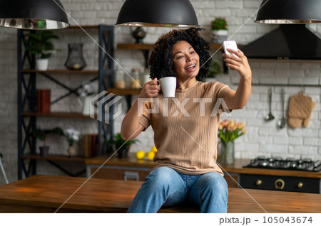 Cute woman with a phone in hands looking excited Cute woman with a phone in hands looking excited 105043674