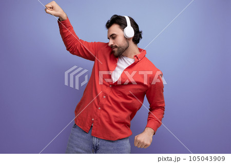 cute caucasian young guy music lover in headphones dancing 105043909