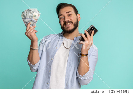 Lebanese man use smartphone rejoicing win, receiving money dollar cash, success lottery jackpot luck 105044697