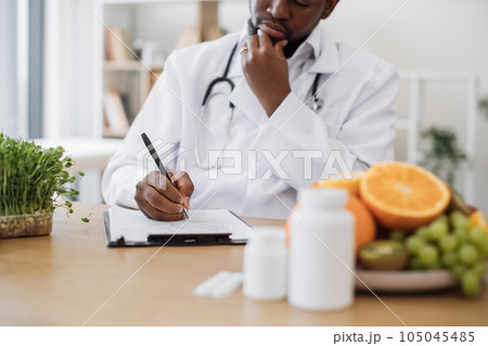 Male expert writing special menu for patient in hospital Male expert writing special menu for patient in hospital 105045485