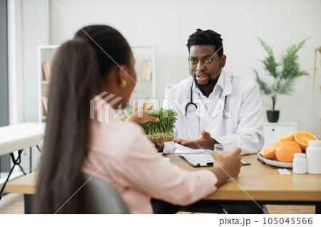 Specialist in food offering micro herbs to patient at work Specialist in food offering micro herbs to patient at work 105045566