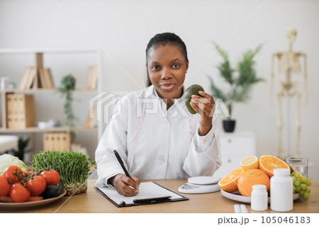 Expert in food choosing avocado for special diet in office Expert in food choosing avocado for special diet in office 105046183