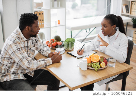 Expert in diet talking to man in consulting room of hospital Expert in diet talking to man in consulting room of hospital 105046523