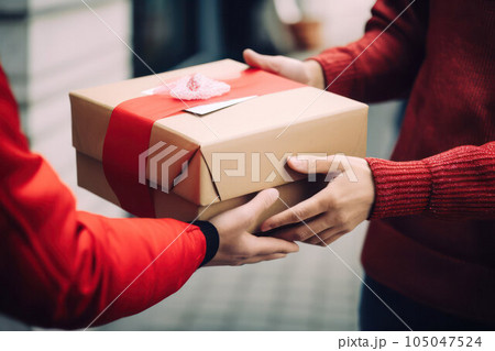 a person receives a gift for the holiday. concept of celebration and attention a person receives a gift for the holiday. concept of celebration and attention 105047524