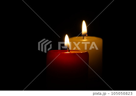 Candle flame in the darkness, hope and memory 105050823