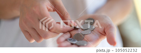 Female counting coins in her hands close up. Female counting coins in her hands close up. 105052232