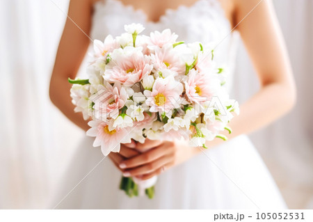 Beautiful wedding bouquet in hands of bride, close-up Beautiful wedding bouquet in hands of bride, close-up 105052531