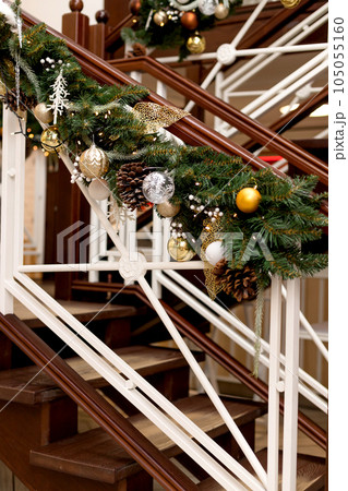 Beautiful wooden staircase with Christmas decor. New year 105055160