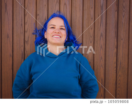 Female wearing light blue oversize hoodie and jeans Female wearing light blue oversize hoodie and jeans 105059808