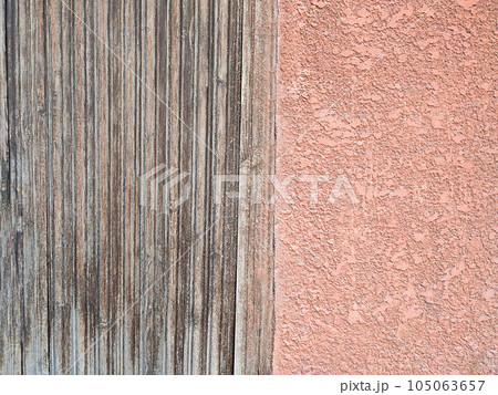 Two textures. Wooden gray slats and beige decorative plaster, texture. Copy space 105063657