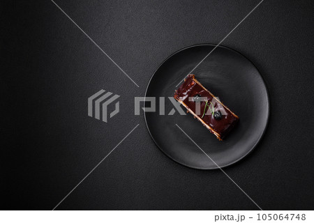 Delicious sweet dessert cheesecake with candied fruits in chocolate Delicious sweet dessert cheesecake with candied fruits in chocolate 105064748