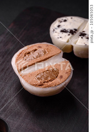 Delicious sweet mochi dessert with toppings on a dark concrete background Delicious sweet mochi dessert with toppings on a dark concrete background 105065053