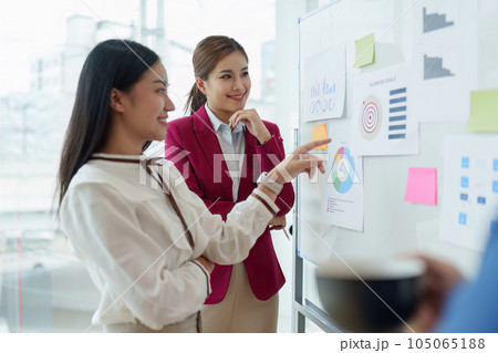 Diverse business team stacking hands and collaboration and analyze financial data for long term investments 105065188