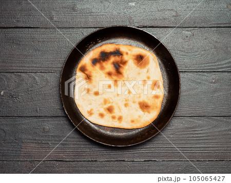 naan flatbread on dark wood, copy space, top view naan flatbread on dark wood, copy space, top view 105065427