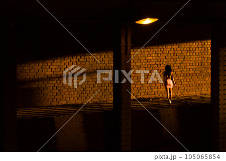 A prostitute waiting for a client in a dark part of the city, the street. A prostitute waiting for a client in a dark part of the city, the street. 105065854