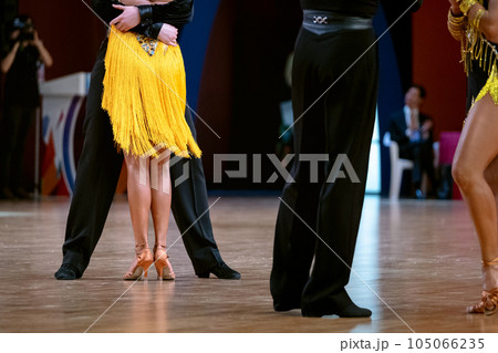 two couple dancers in dancesport competition, cha-cha-cha dance 105066235