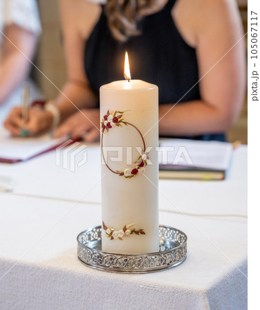 The wedding candle for the bride and groom. candle is the family hearth symbol at a wedding The wedding candle for the bride and groom. candle is the family hearth symbol at a wedding 105067117