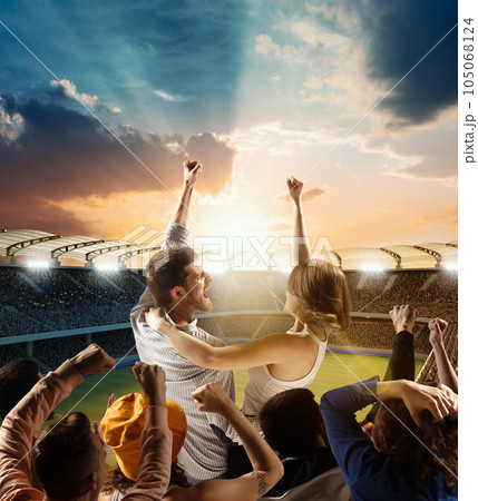Football fans support their team, excited couple chanting name of team over evening sport arena, 3d model. Concept of sport, emotions, competition. Football fans support their team, excited couple chanting name of team over evening sport arena, 3d model. Concept of sport, emotions, competition. 105068124